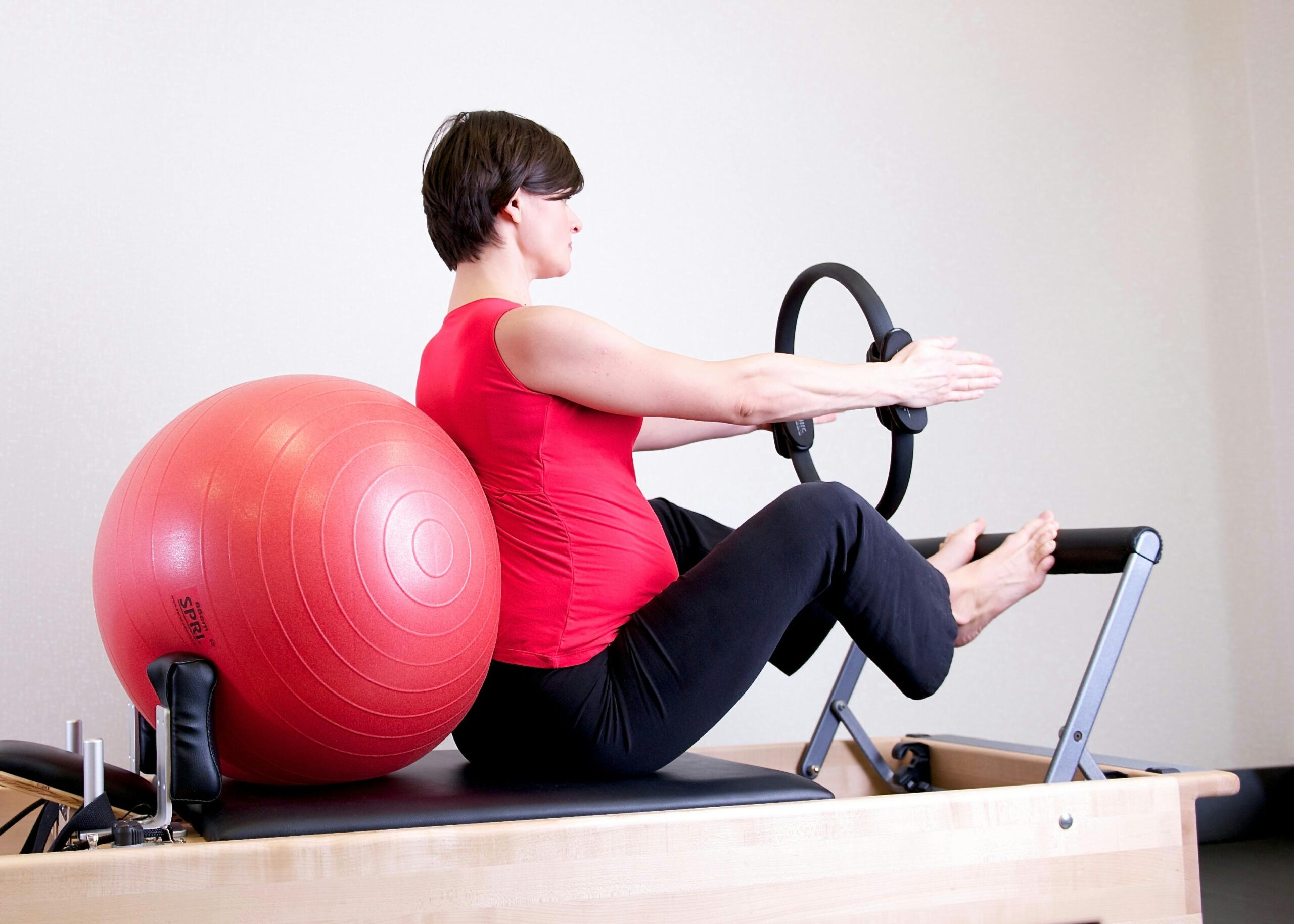 Woman doing Pilates reformer exercise to improve golf performance
